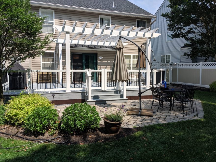 Trex Pebble Gray Decking with White Washington Vinyl Railing with Black Round Aluminum Balusters + Double Gate + White Vinyl Pergola